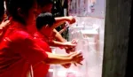 A group of children raise their hands whilst taking part of Lifebuoy’s handwashing programme